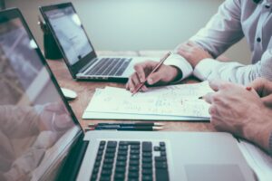 A medical malpractice lawyer Chicago sitting at a desk with a plaintiff going over details of their malpractice claim