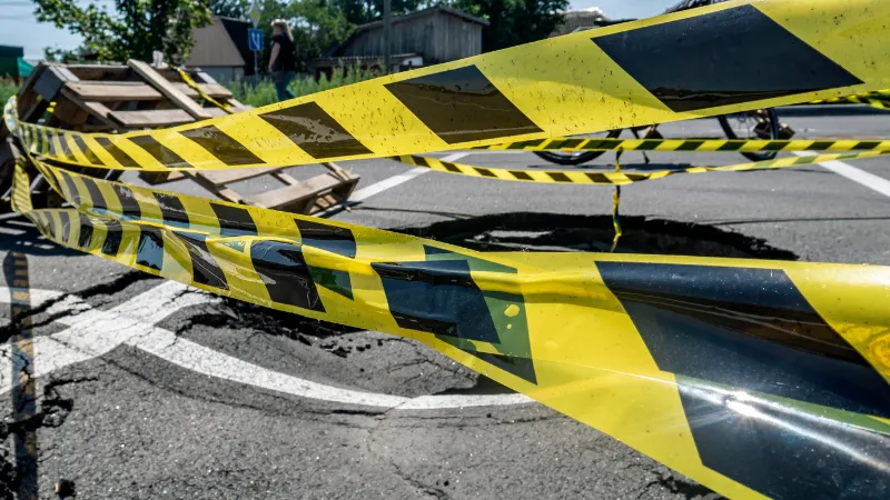 Dangerous stretch of road with damaged asphalt.