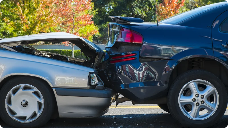 Two cars that have been involved in a rear-end collision.