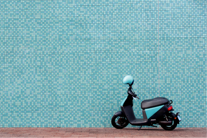 moped infront of a blue wall